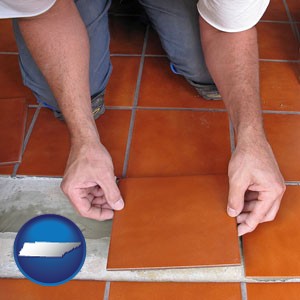 a tile worker laying ceramic floor tile - with Tennessee icon