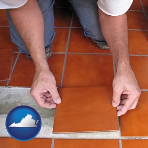 a tile worker laying ceramic floor tile - with Virginia icon